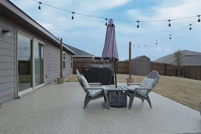 view of patio with a fenced backyard, area for grilling, a storage shed, and an outdoor structure