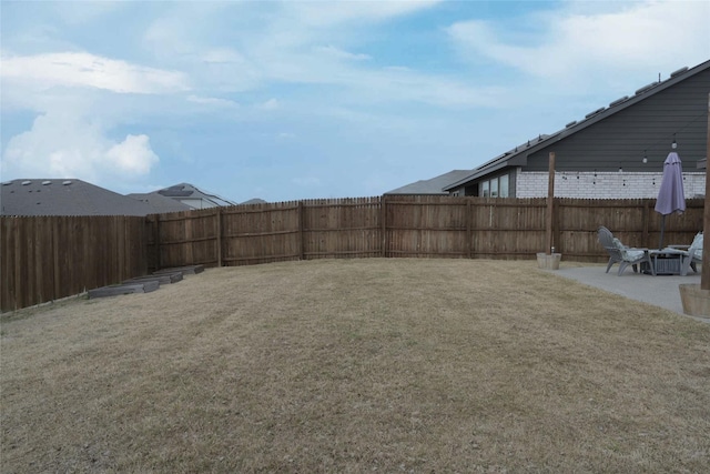 view of yard with a patio and a fenced backyard