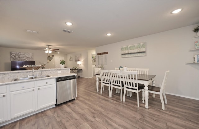 kitchen featuring visible vents, wood finished floors, white cabinetry, a ceiling fan, and stainless steel dishwasher