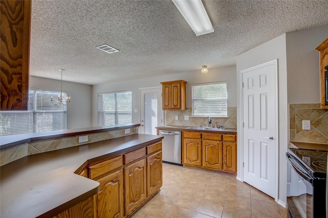 kitchen featuring a sink, stainless steel dishwasher, brown cabinetry, visible vents, and black electric range