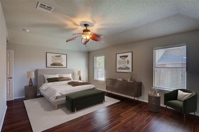 bedroom featuring baseboards, visible vents, wood finished floors, and ceiling fan