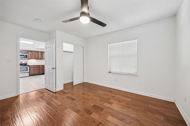 5609 Fursman Ave, Fort Worth, TX 76114 - unfurnished bedroom featuring wood finished floors, baseboards, a closet, and a ceiling fan