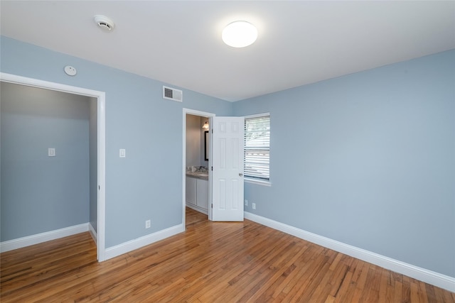 1717 E 15th St, Plano, TX 75074 - unfurnished bedroom with baseboards and light wood finished floors