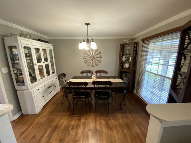 1704 S Houston St, Kaufman, TX 75142 - dining space featuring dark wood-style flooring, a chandelier, ornamental molding, and baseboards