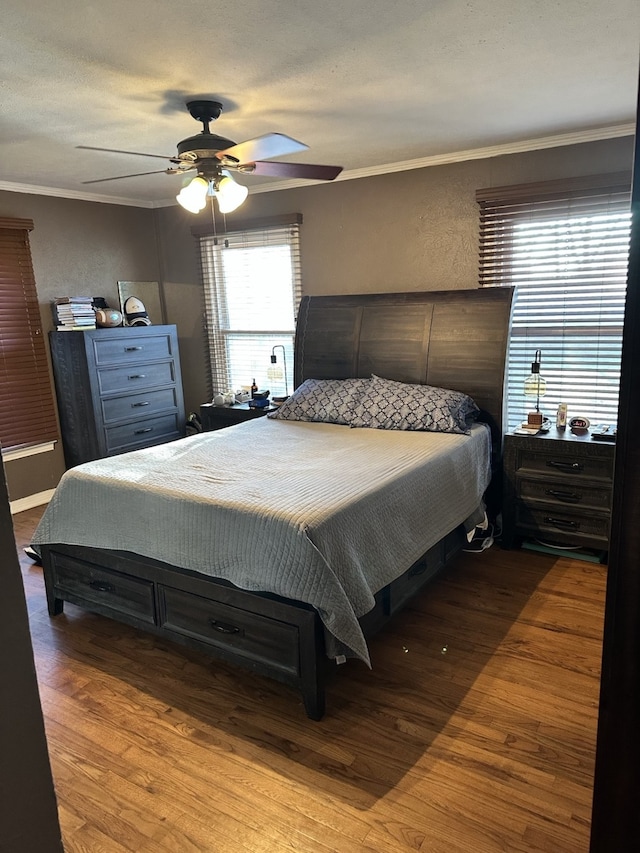 1704 S Houston St, Kaufman, TX 75142 - bedroom with crown molding, wood finished floors, a ceiling fan, and a textured wall
