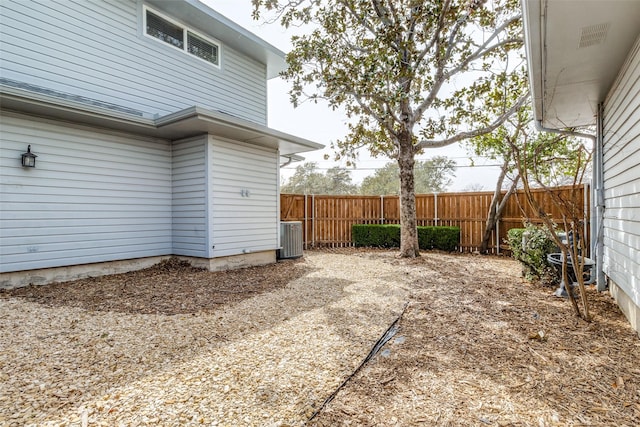 exterior space featuring central AC and fence