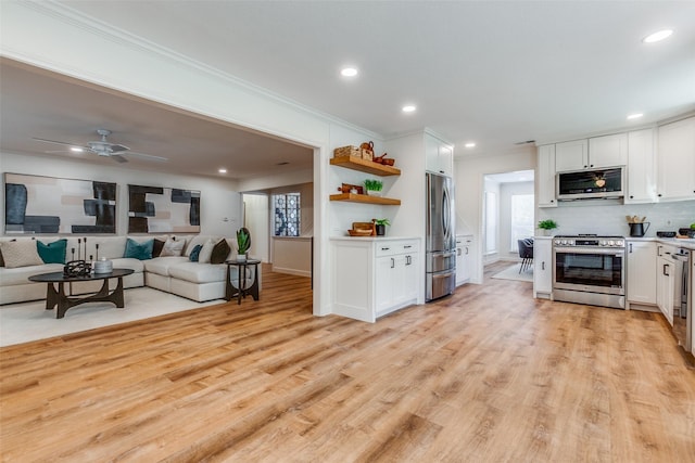 kitchen featuring crown molding, white cabinets, open shelves, and stainless steel appliances