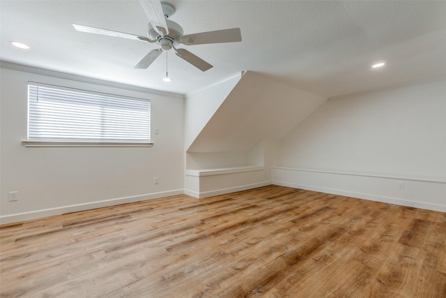additional living space with light wood-style flooring, recessed lighting, ceiling fan, and baseboards
