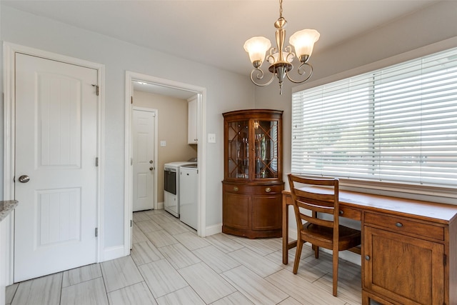 interior space with a chandelier, washer and dryer, and baseboards