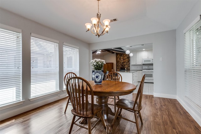 dining room featuring plenty of natural light, visible vents, and wood finished floors