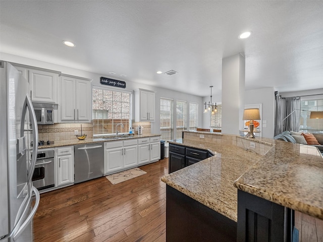 7601 Glenwood Springs Ln, Mckinney, TX 75070 - kitchen featuring a sink, dark wood-style flooring, recessed lighting, stainless steel appliances, and decorative backsplash