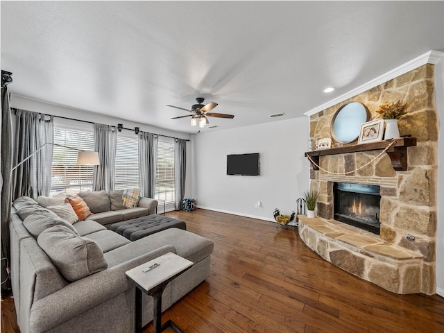 7601 Glenwood Springs Ln, Mckinney, TX 75070 - living room with ceiling fan, a fireplace, visible vents, wood-type flooring, and baseboards