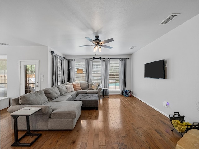 7601 Glenwood Springs Ln, Mckinney, TX 75070 - living room with visible vents, ceiling fan, hardwood / wood-style floors, and baseboards