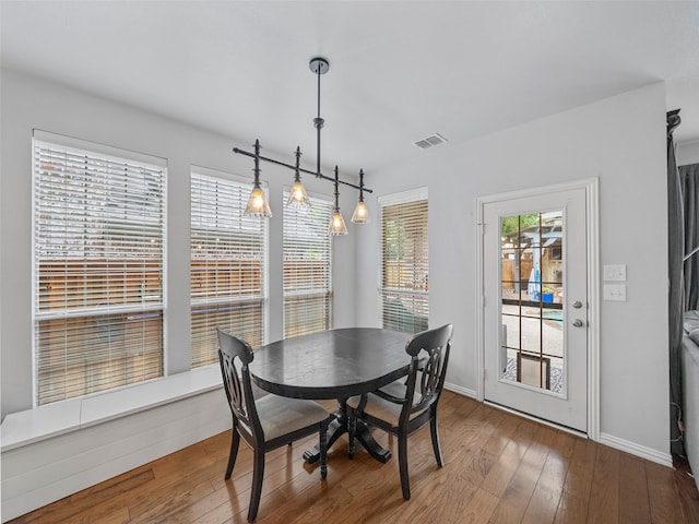 7601 Glenwood Springs Ln, Mckinney, TX 75070 - dining area with baseboards, wood-type flooring, and visible vents