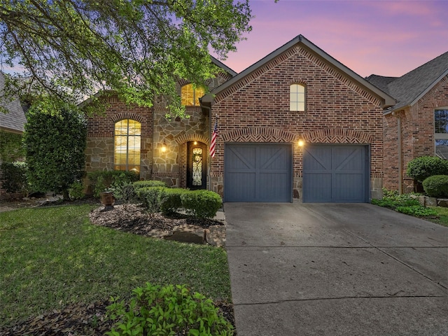 7601 Glenwood Springs Ln, Mckinney, TX 75070 - view of front of property with a yard, stone siding, a garage, brick siding, and driveway