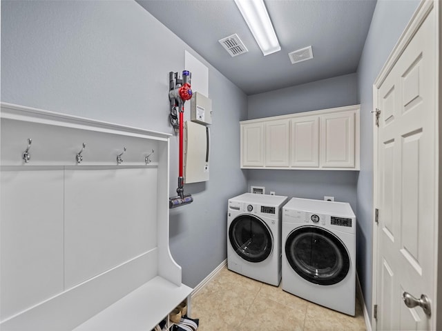 7601 Glenwood Springs Ln, Mckinney, TX 75070 - laundry room featuring visible vents, washing machine and clothes dryer, baseboards, and cabinet space