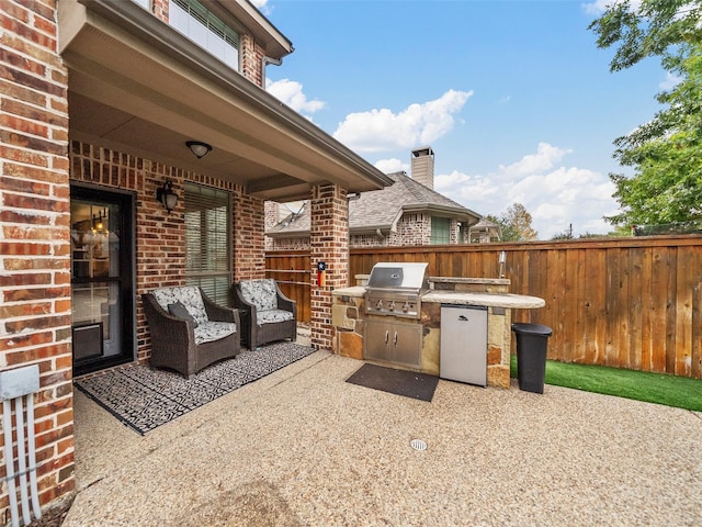 7601 Glenwood Springs Ln, Mckinney, TX 75070 - view of patio with fence, exterior kitchen, and area for grilling