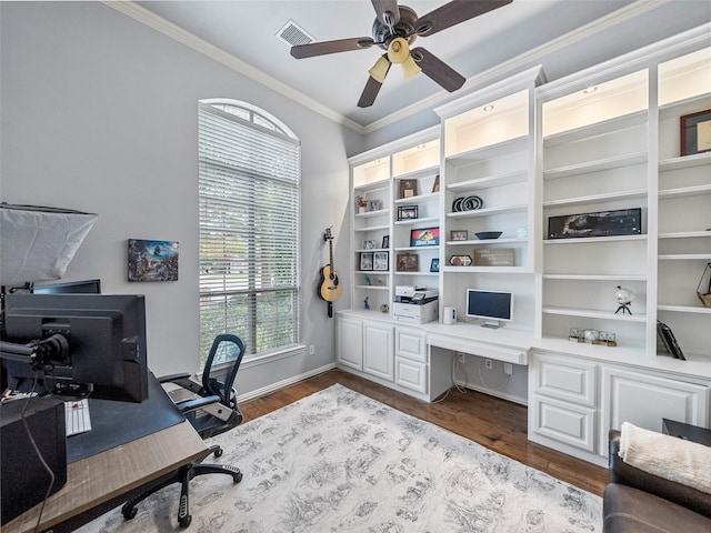 7601 Glenwood Springs Ln, Mckinney, TX 75070 - home office featuring baseboards, ornamental molding, a ceiling fan, dark wood-type flooring, and visible vents