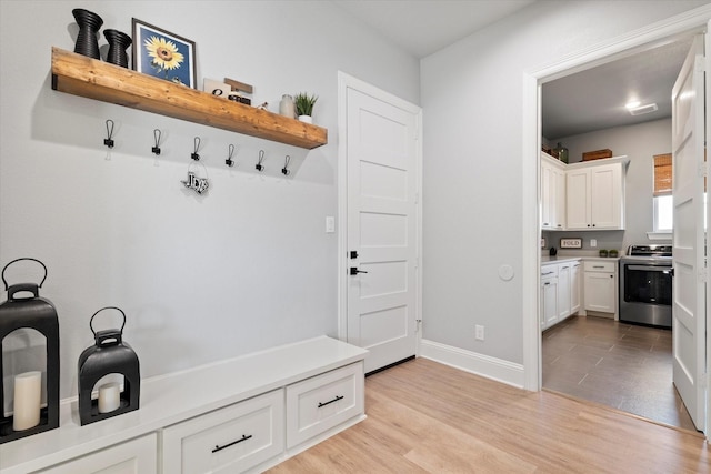 mudroom featuring light wood-type flooring and baseboards