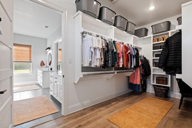 walk in closet with wood finished floors and visible vents