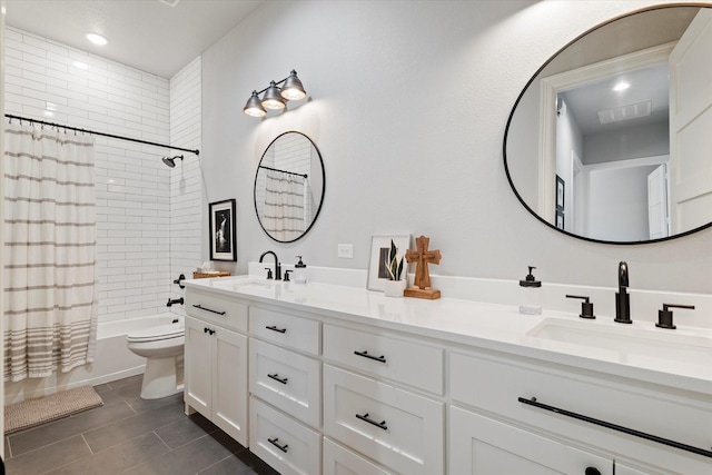 bathroom featuring double vanity, toilet, shower / bath combo, and a sink