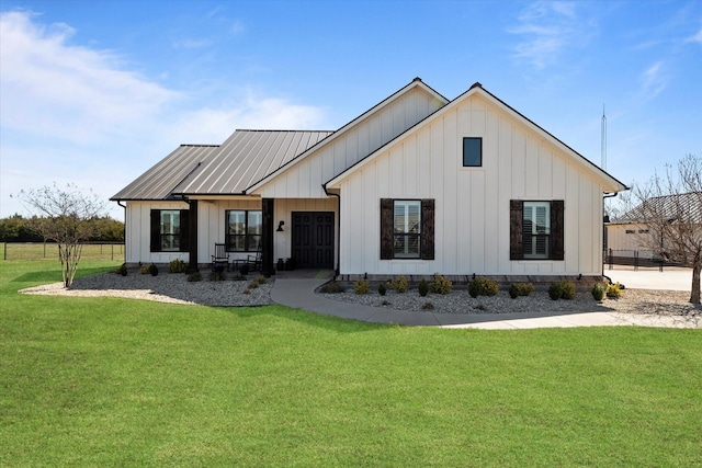 modern inspired farmhouse featuring board and batten siding and a front yard