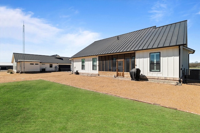 back of property featuring a yard, board and batten siding, metal roof, and a standing seam roof