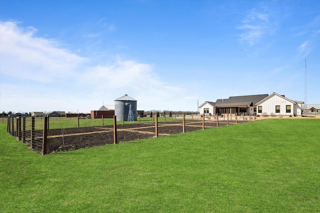 view of yard with a rural view and fence