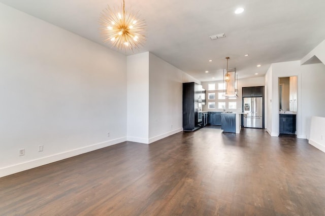 4609 Steel St, Dallas, TX 75219 - unfurnished living room featuring recessed lighting, visible vents, a notable chandelier, and dark wood-style floors
