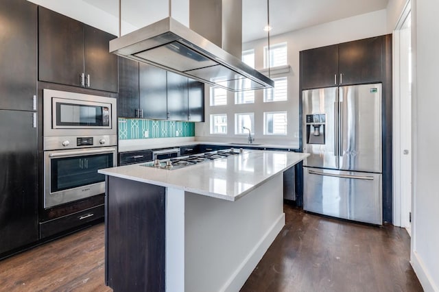 4609 Steel St, Dallas, TX 75219 - kitchen featuring dark wood-type flooring, a sink, a kitchen island, appliances with stainless steel finishes, and exhaust hood
