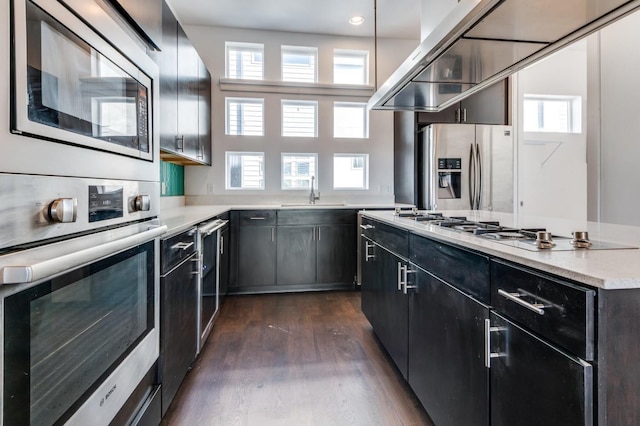 4609 Steel St, Dallas, TX 75219 - kitchen with dark wood-type flooring, a sink, dark cabinetry, a center island, and stainless steel appliances