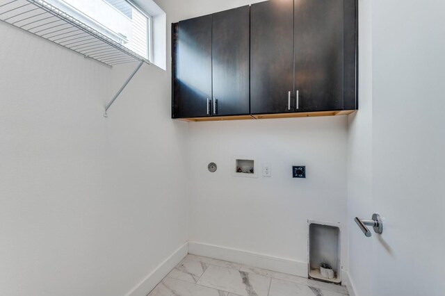 4609 Steel St, Dallas, TX 75219 - clothes washing area with electric dryer hookup, marble finish floor, cabinet space, baseboards, and hookup for a washing machine