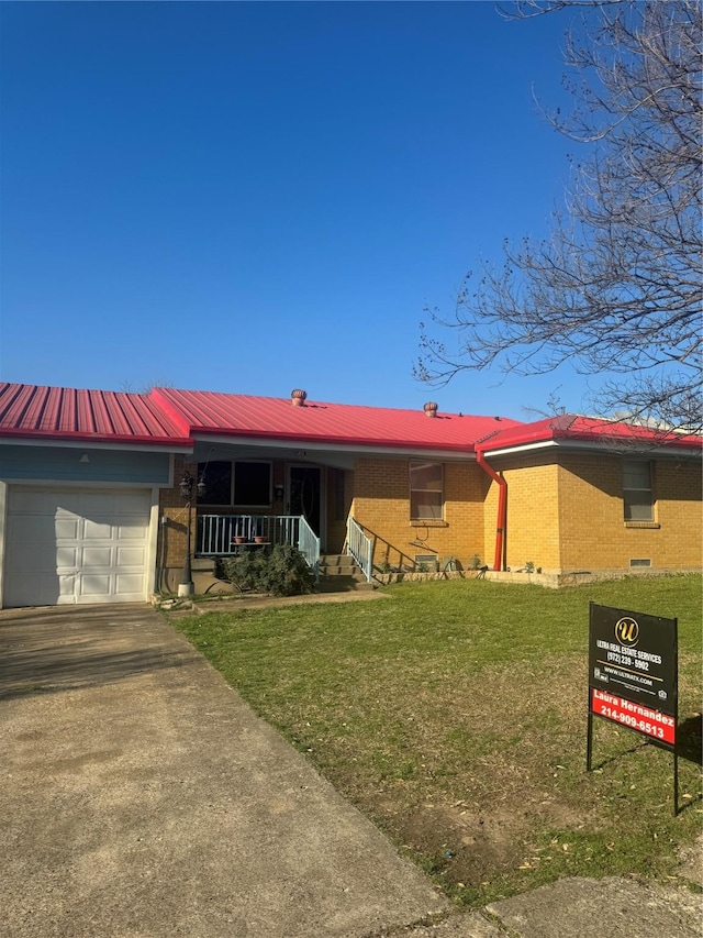 ranch-style home with brick siding, covered porch, an attached garage, and a front lawn