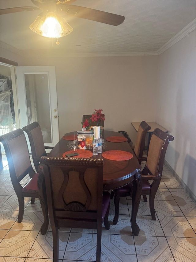 dining area with baseboards and ornamental molding