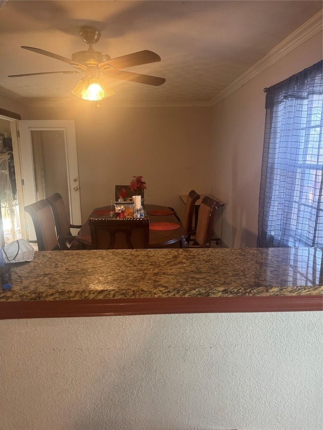 dining area with ceiling fan and ornamental molding