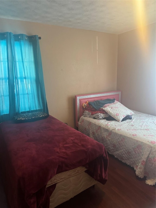 bedroom featuring wood finished floors