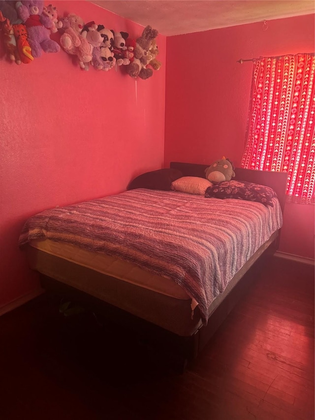 bedroom with wood finished floors