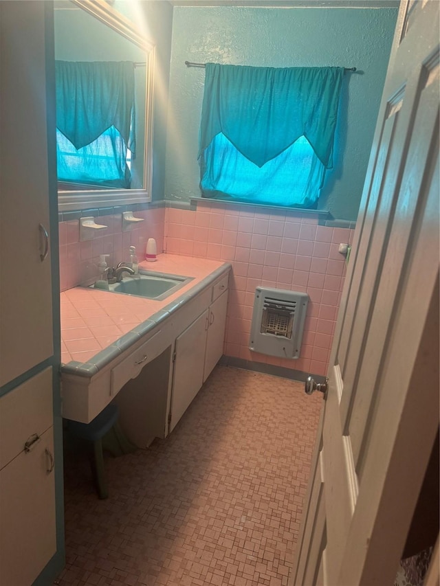 bathroom with tile walls, heating unit, and a wainscoted wall