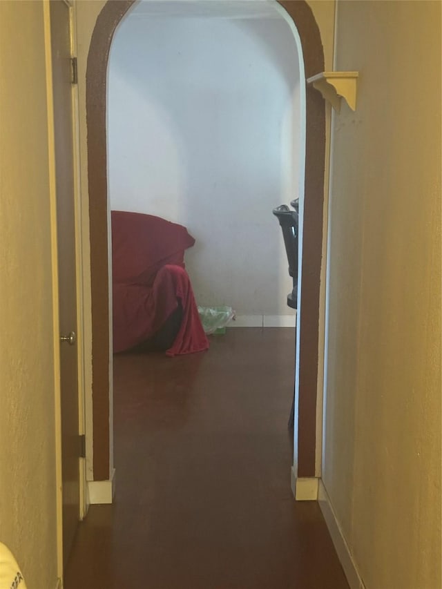 corridor featuring arched walkways