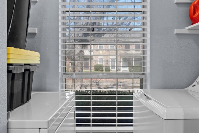 details featuring washer and clothes dryer and a textured wall
