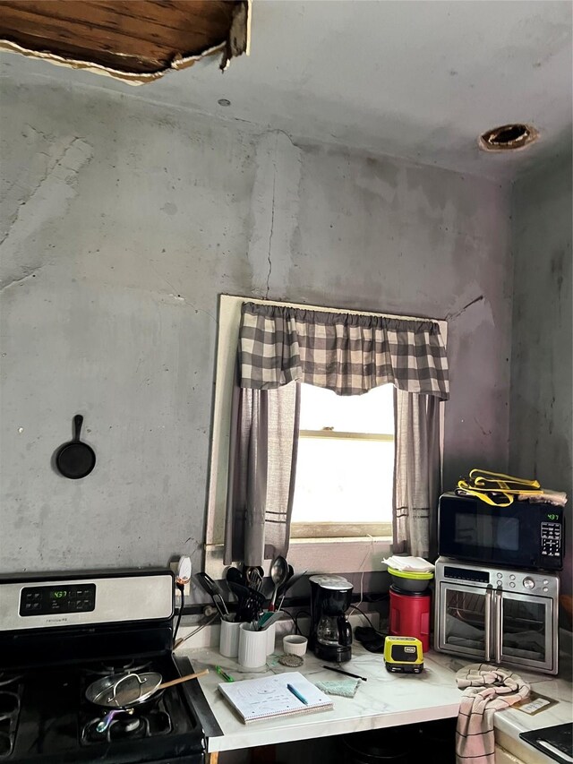 kitchen with gas stove and black microwave