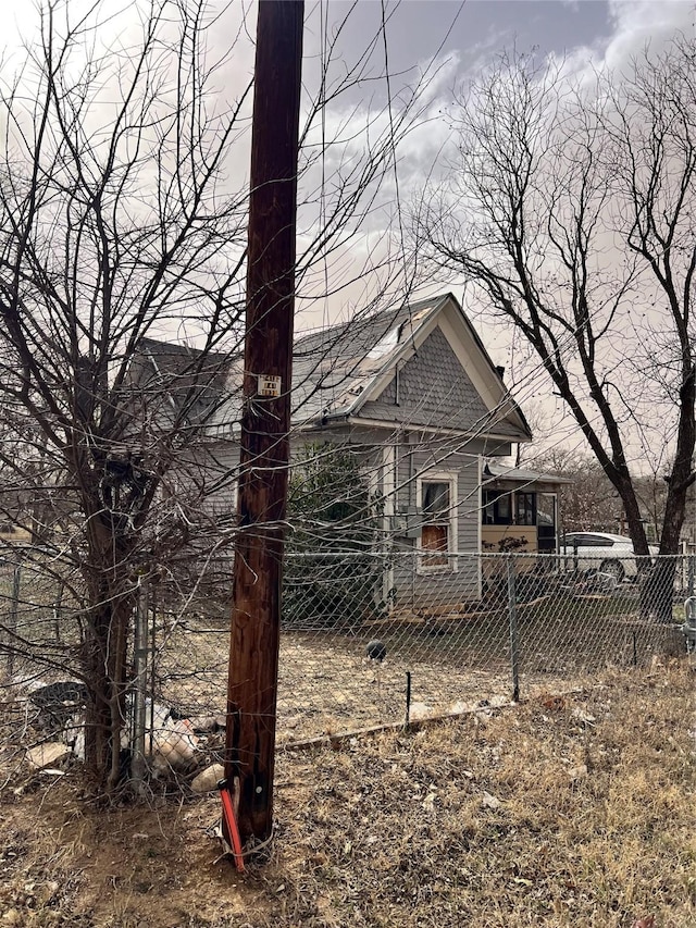 rear view of house featuring fence