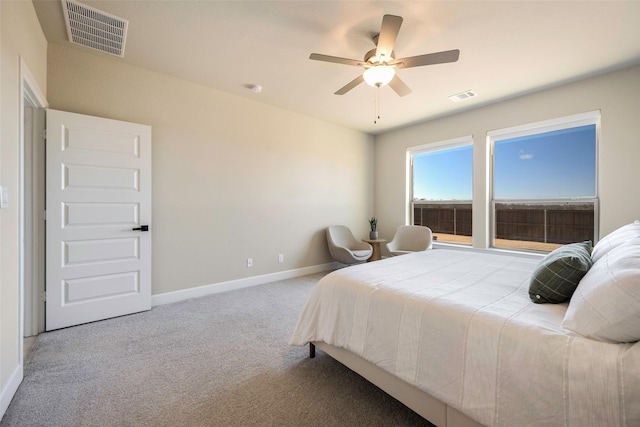 bedroom with baseboards, a ceiling fan, carpet flooring, and visible vents
