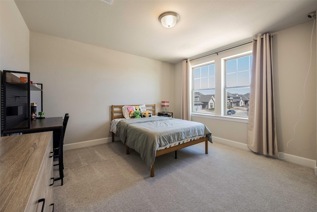 bedroom with baseboards and carpet flooring