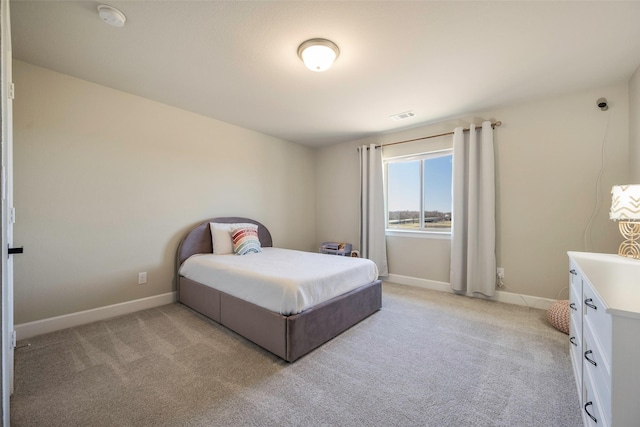 bedroom with visible vents, light carpet, and baseboards