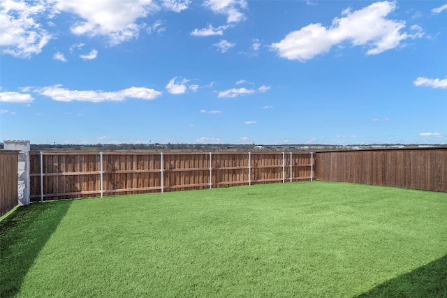 view of yard with a fenced backyard