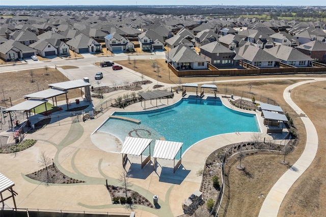 pool with fence and a residential view