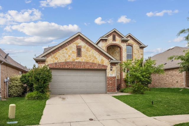 1605 Tahoe Trl, Prosper, TX 75078 - traditional-style home featuring an attached garage, brick siding, stone siding, a front yard, and driveway