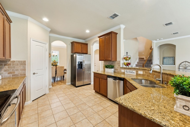 1605 Tahoe Trl, Prosper, TX 75078 - kitchen featuring a sink, appliances with stainless steel finishes, arched walkways, and visible vents
