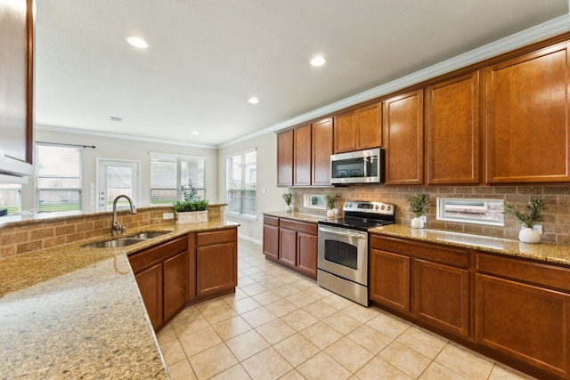 1605 Tahoe Trl, Prosper, TX 75078 - kitchen with ornamental molding, light tile patterned flooring, tasteful backsplash, a sink, and appliances with stainless steel finishes
